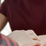 man holding hands of spouse