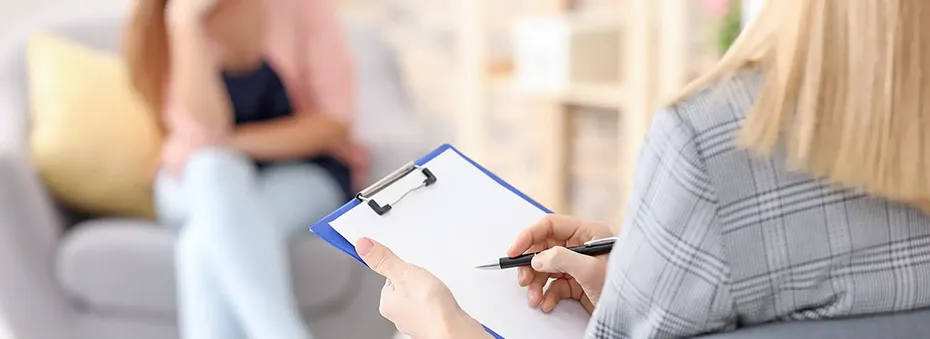 woman writing down symptoms