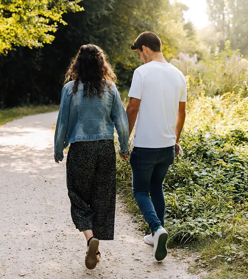 rear-view-couple-walking-outdoors