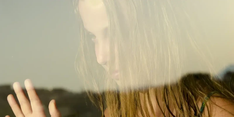 child girl with hair face look through window