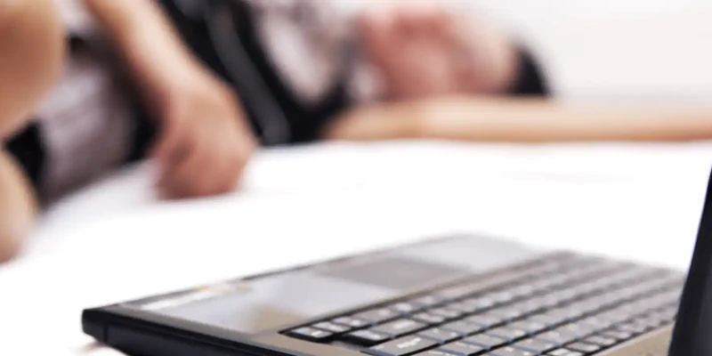 close up woman sleeping by laptop bed