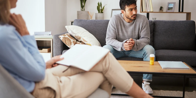 depression psychologist talking man patient sofa medical support