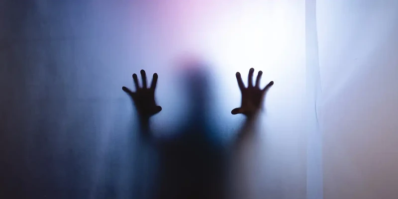 silhouette hand touching illuminated lights