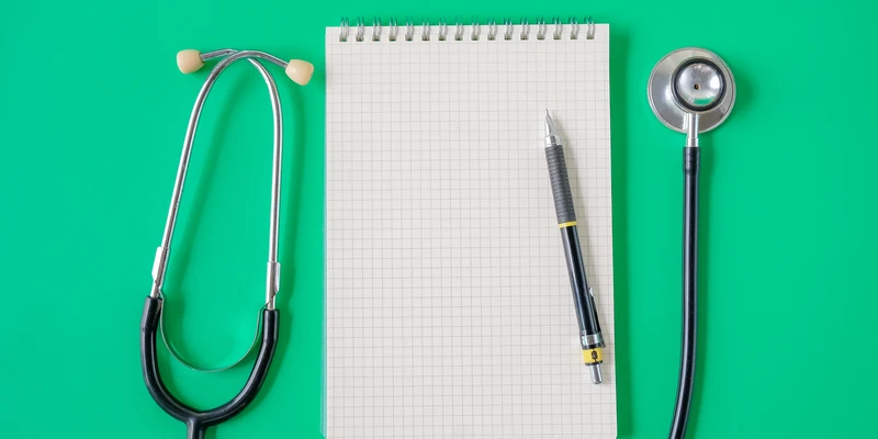 stethoscope noted book with penselective focus