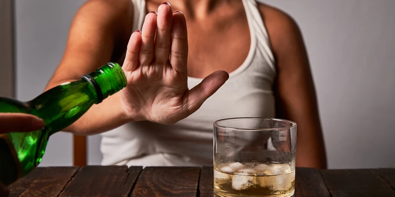 woman s hand saying put any more drink